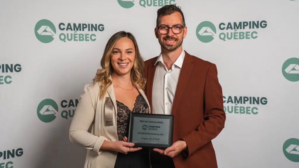 a man and woman holding a plaque